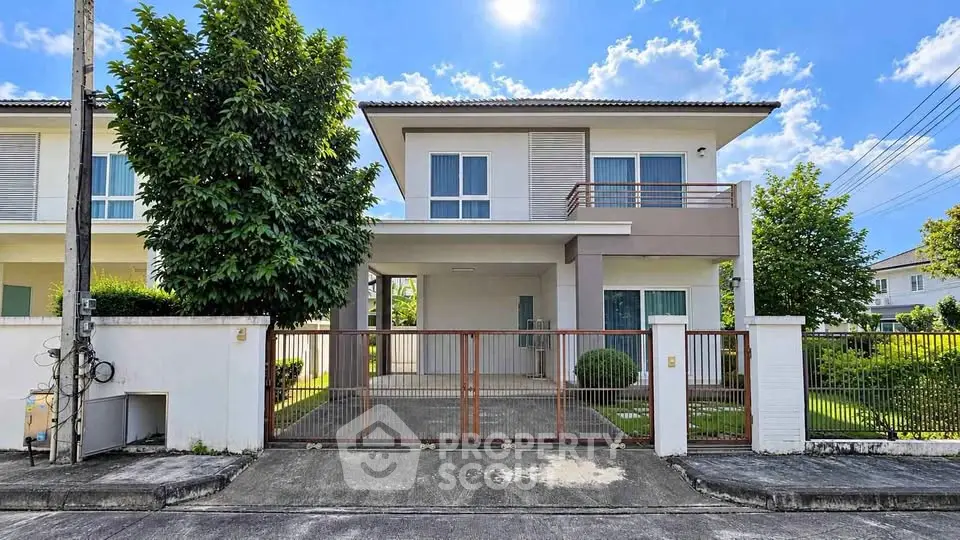 Modern two-story house with spacious driveway and lush greenery, perfect for family living.