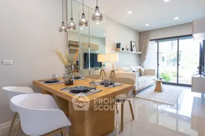 Modern open-plan living room with dining area and large windows in stylish apartment
