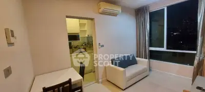 Cozy living room with city view and compact kitchen