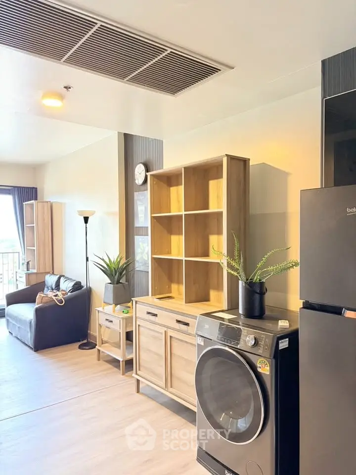 Modern living room with washing machine and stylish furniture
