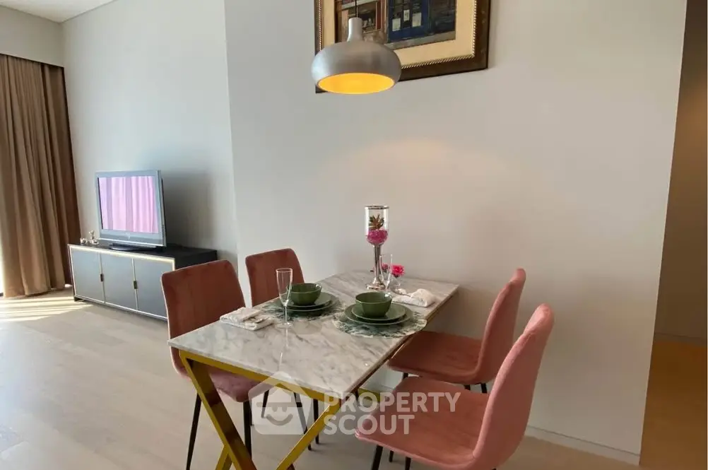 Stylish dining area with modern decor and natural lighting in a cozy apartment.
