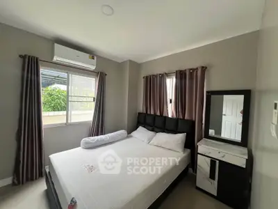 Cozy bedroom with modern furnishings and natural light in a stylish home.