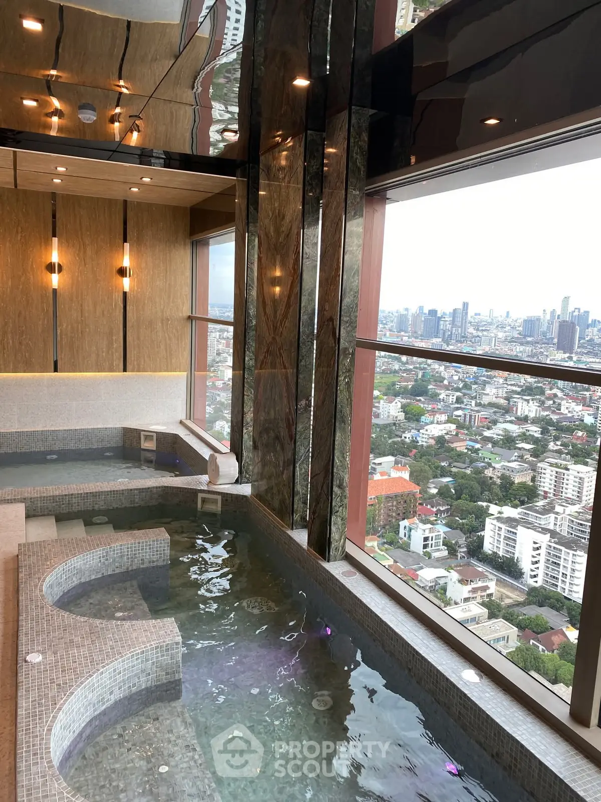 Luxurious indoor pool with stunning city view from high-rise building