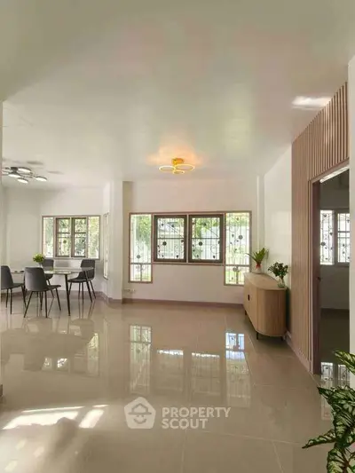 Spacious modern living room with dining area and stylish lighting