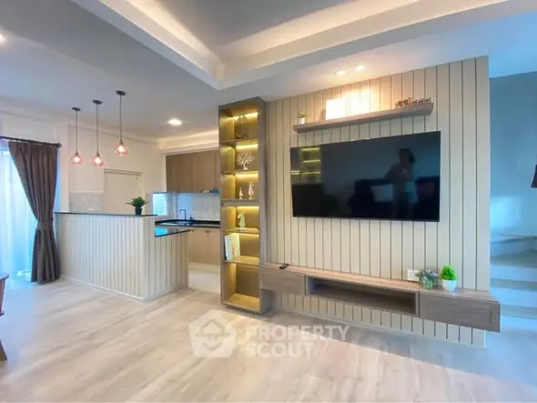 Modern open-plan living room with stylish kitchen and elegant lighting