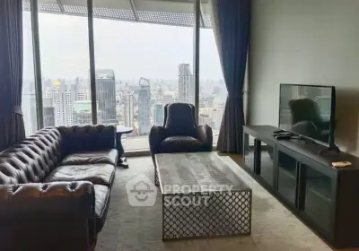 Luxurious living room with stunning city view, featuring elegant leather sofas and modern entertainment setup.