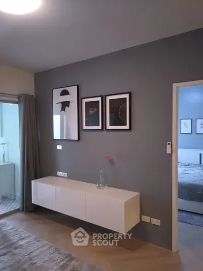 Stylish modern living room with elegant wall art and sleek furniture design.