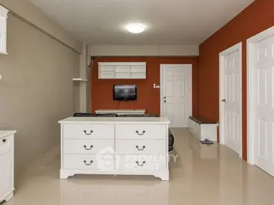 Modern living room with sleek furniture and neutral tones, perfect for relaxation and entertainment.