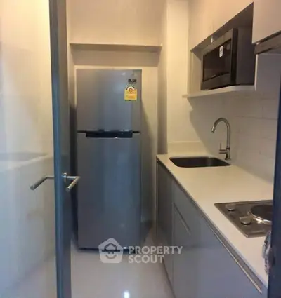 Compact modern kitchen with sleek appliances and minimalist design