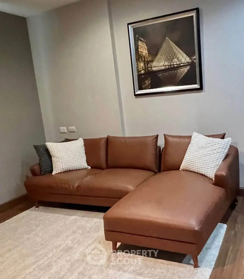 Stylish living room with brown leather sectional sofa and modern artwork, perfect for contemporary homes.
