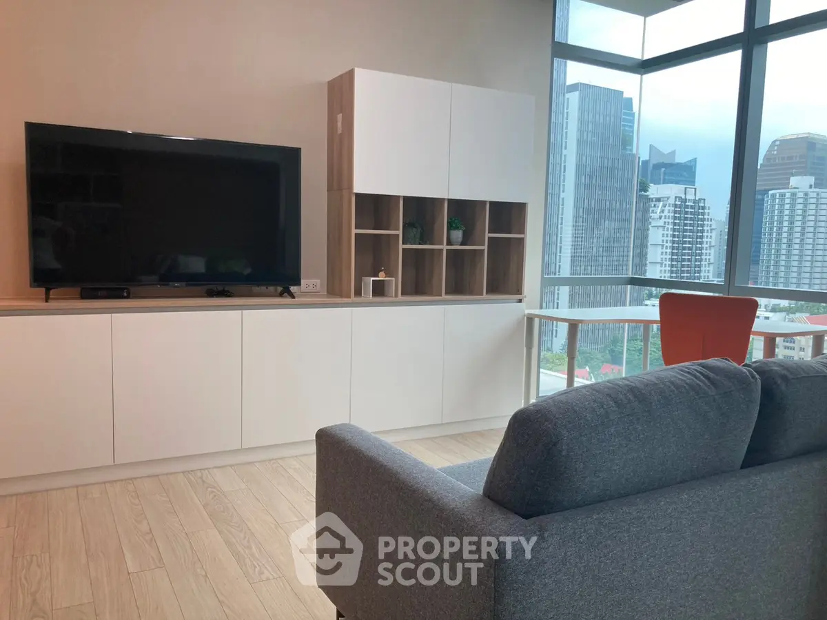 Modern living room with city view, stylish furniture, and large windows.