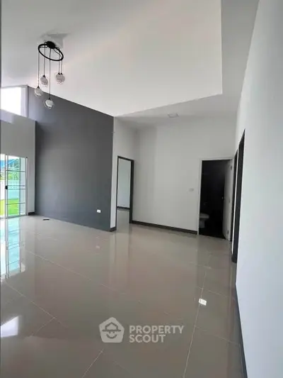 Spacious modern living room with high ceilings and large windows for natural light.