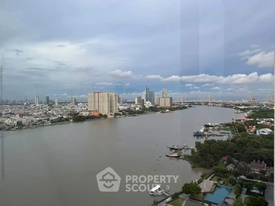 Stunning river view from high-rise apartment showcasing city skyline and serene waters.