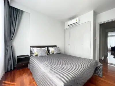 Modern bedroom with stylish decor and ample natural light in a contemporary apartment.