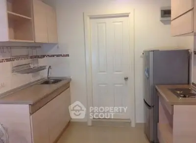 Modern kitchen with sleek cabinetry and stainless steel appliances in a compact layout.