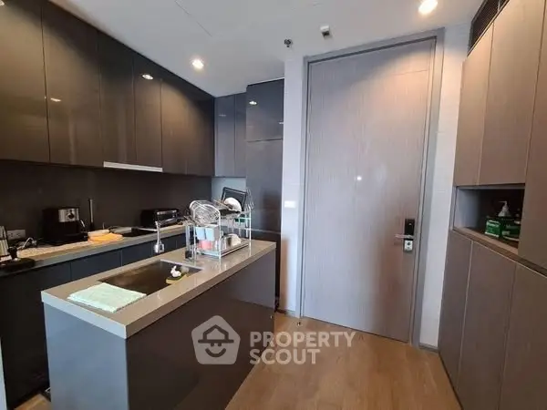 Modern kitchen with sleek cabinetry and island in luxury apartment