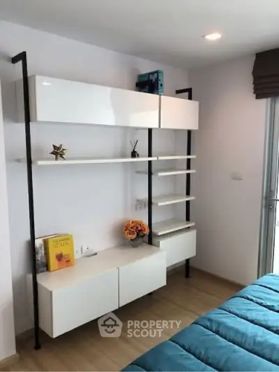 Modern bedroom with sleek shelving and cozy decor