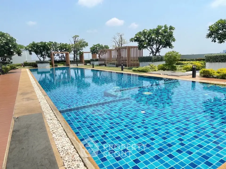 Luxurious rooftop pool with stunning city views and lush greenery, perfect for relaxation and leisure.