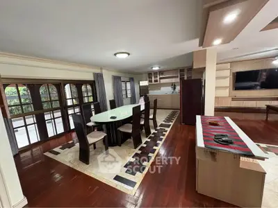 Spacious dining area with elegant wooden flooring and modern furnishings