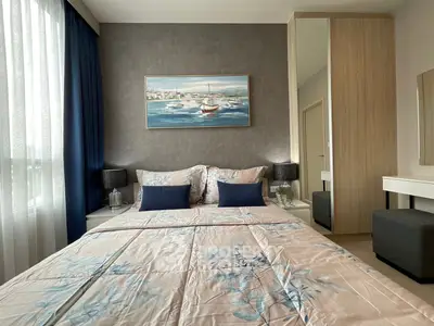 Elegant bedroom with stylish decor and natural light, featuring a cozy bed and modern furnishings.