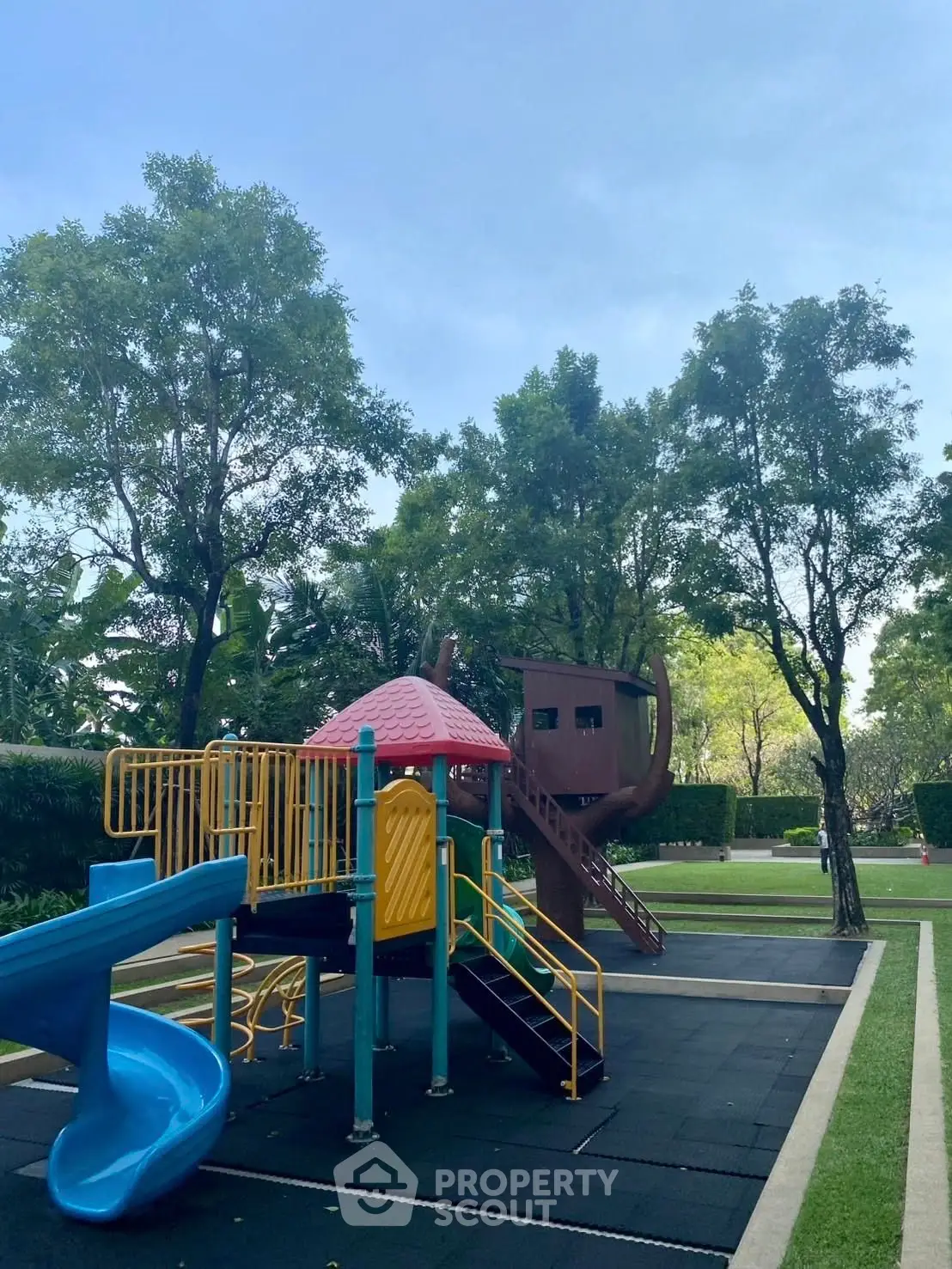 Charming outdoor playground in lush garden setting, perfect for family-friendly residential communities.
