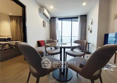 Modern living room with dining area and bedroom view in stylish apartment