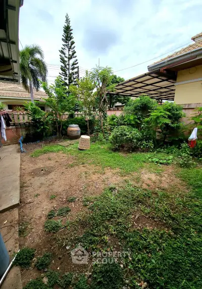 Charming garden space with lush greenery and potential for landscaping in a residential property.