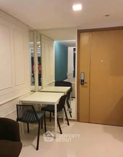 Modern apartment entrance with dining area and sleek design