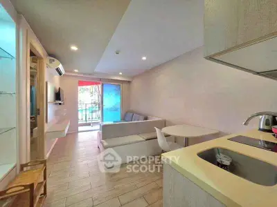 Modern living room with open kitchen and balcony view