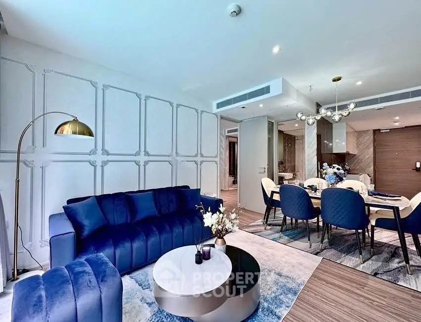 Luxurious modern living room with elegant blue furniture and stylish dining area