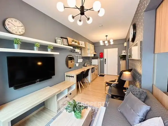 Modern living room with stylish decor and open kitchen layout, featuring contemporary lighting and cozy seating.