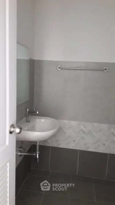Modern bathroom with sleek sink and stylish tile design.