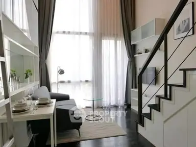 Modern living room with high ceilings and elegant staircase