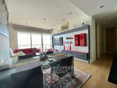 Modern living room with stylish decor and large windows offering natural light.