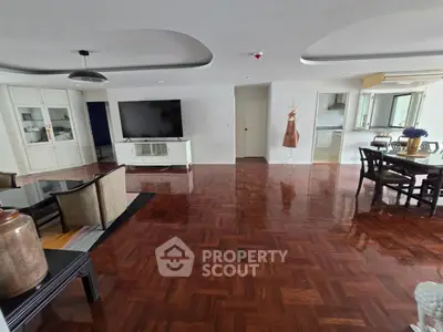 Spacious living room with elegant wooden flooring and modern furniture