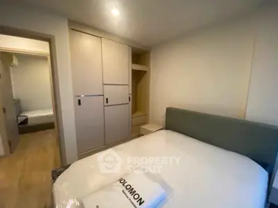 Modern bedroom with sleek wardrobe and cozy bed in a stylish apartment.