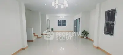 Spacious modern living room with elegant lighting and glossy tiled floors