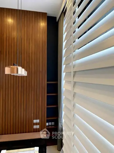 Modern interior with wooden paneling and stylish blinds in a contemporary living space.