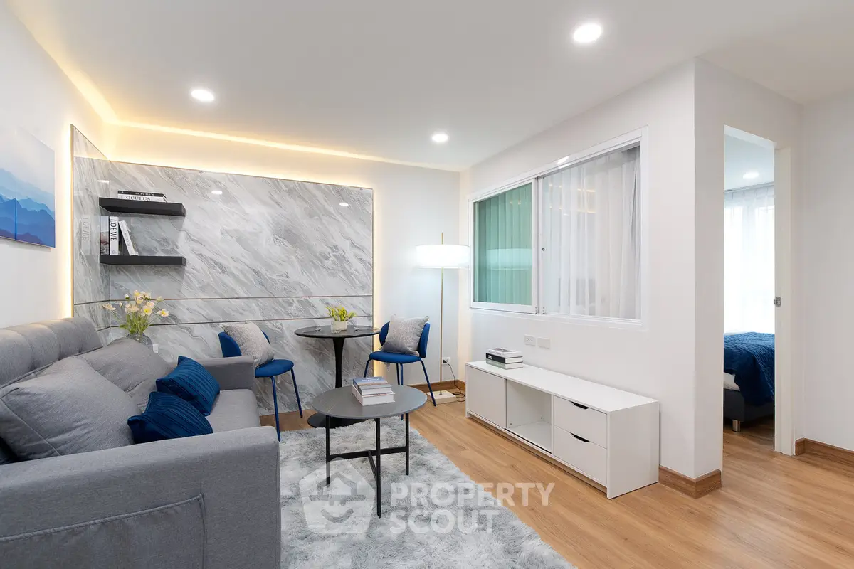 Modern living room with stylish decor and cozy ambiance, featuring a comfortable sofa and elegant lighting.