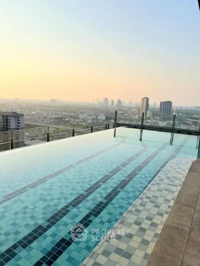 Stunning rooftop infinity pool with panoramic city skyline view at sunset