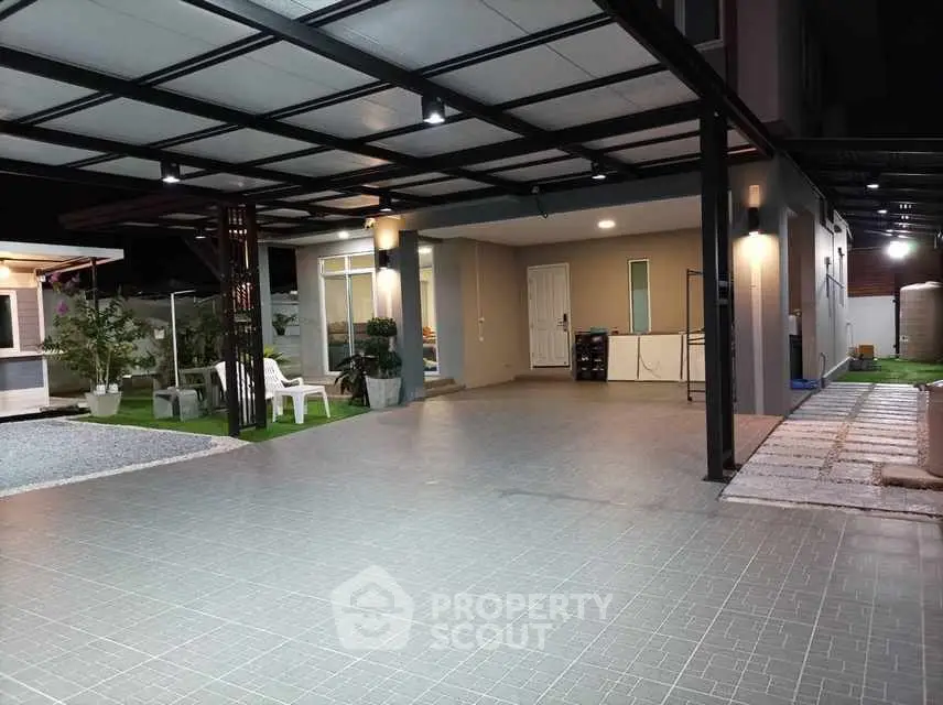 Modern home exterior with spacious tiled driveway and covered carport