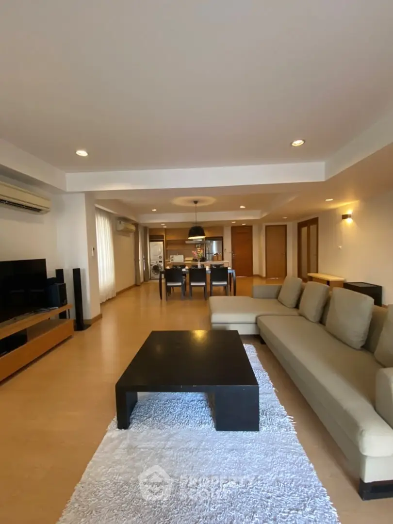 Spacious open-layout living room with modern furniture and dining area