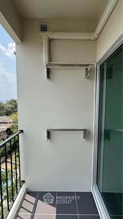 Modern balcony with sleek railing and city view, perfect for relaxation and enjoying the outdoors.
