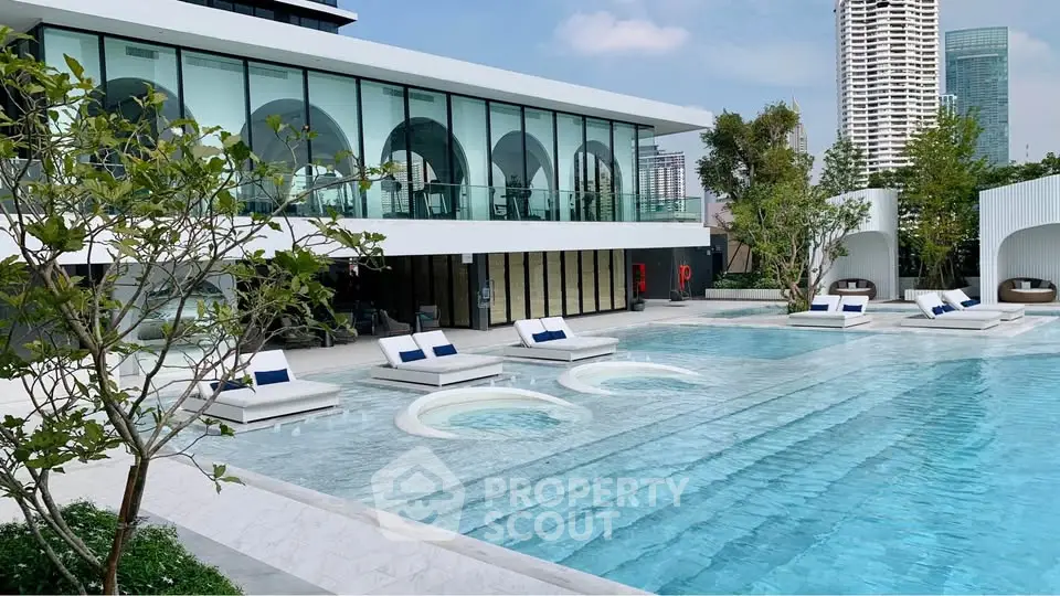 Luxurious modern pool area with stylish loungers and city skyline view, perfect for relaxation and leisure.
