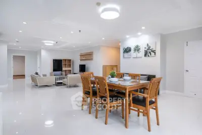 Spacious open-plan living and dining area with modern furnishings and elegant decor.