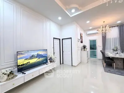 Elegant living and dining area with modern decor and chandelier lighting