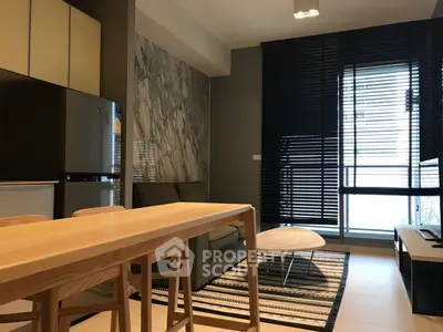 Modern living room with sleek furniture and large windows in a stylish apartment.