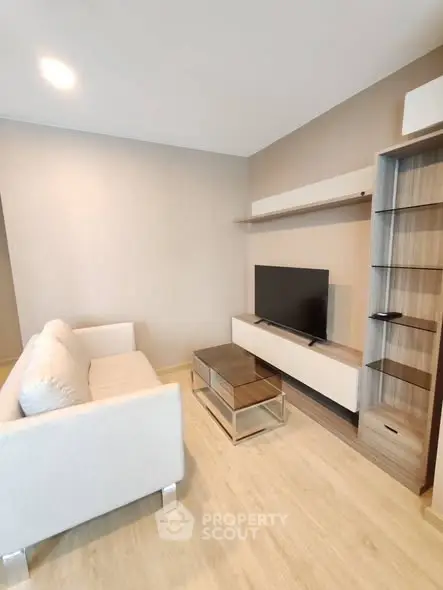 Modern living room with sleek furniture and mounted TV, perfect for cozy relaxation.