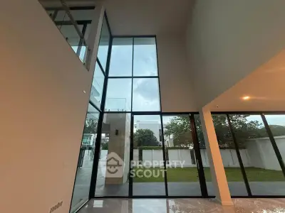Stunning modern living room with floor-to-ceiling windows and garden view