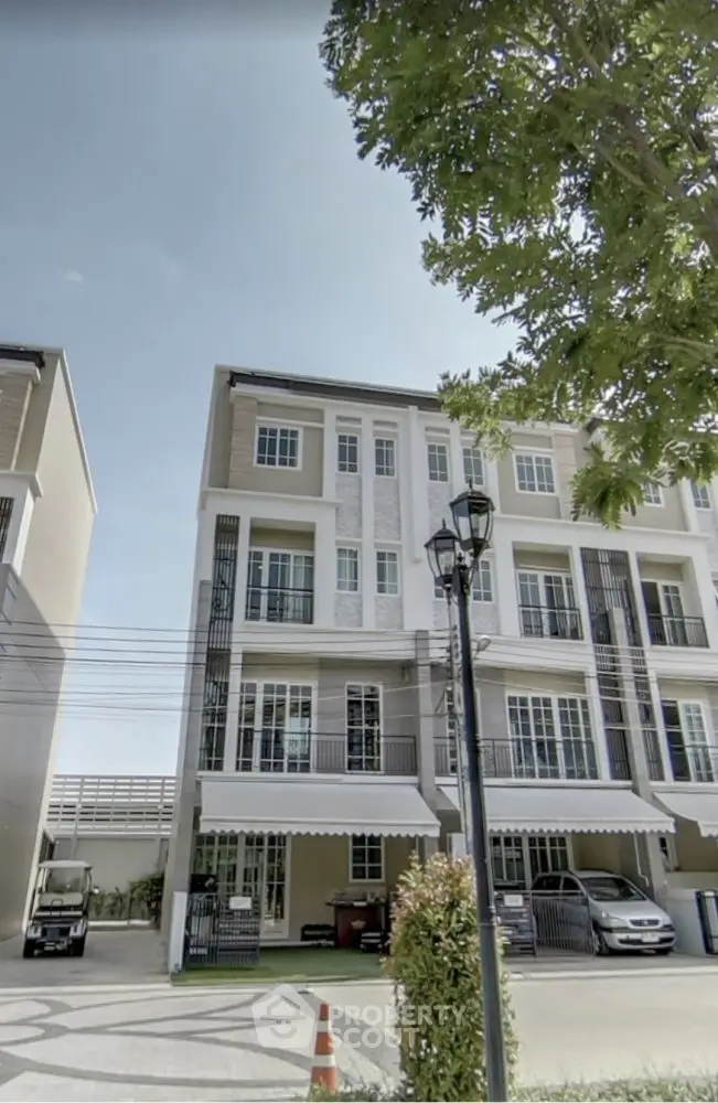 Modern townhouse exterior with multiple floors and large windows, ideal for urban living.